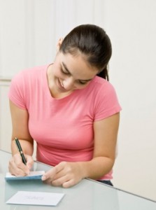 girl writing thank you notes after wedding