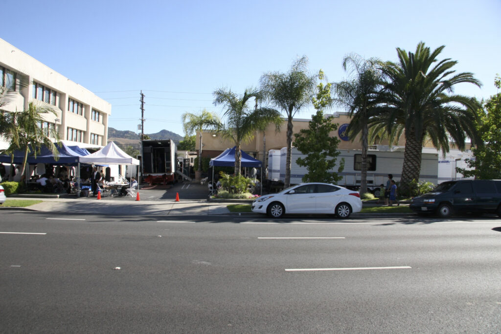 a street with cars and tents along it