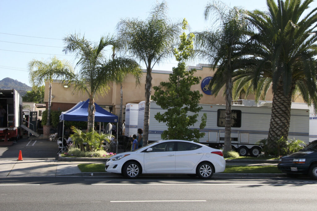 a white car parked in front of a building