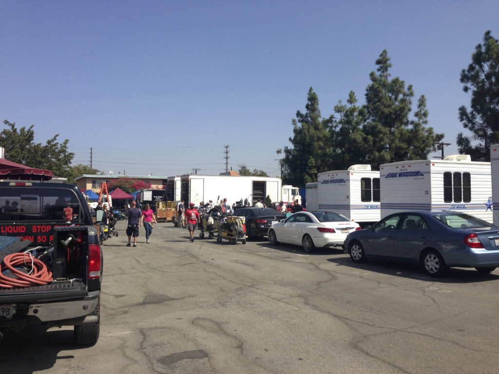 a group of people walking around a food truck