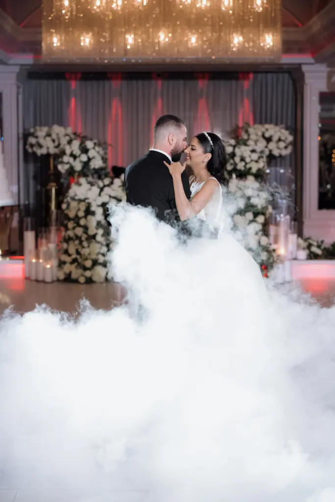 Bride and groom dancing amid stage fog on the Glenoaks Ballroom dance floor