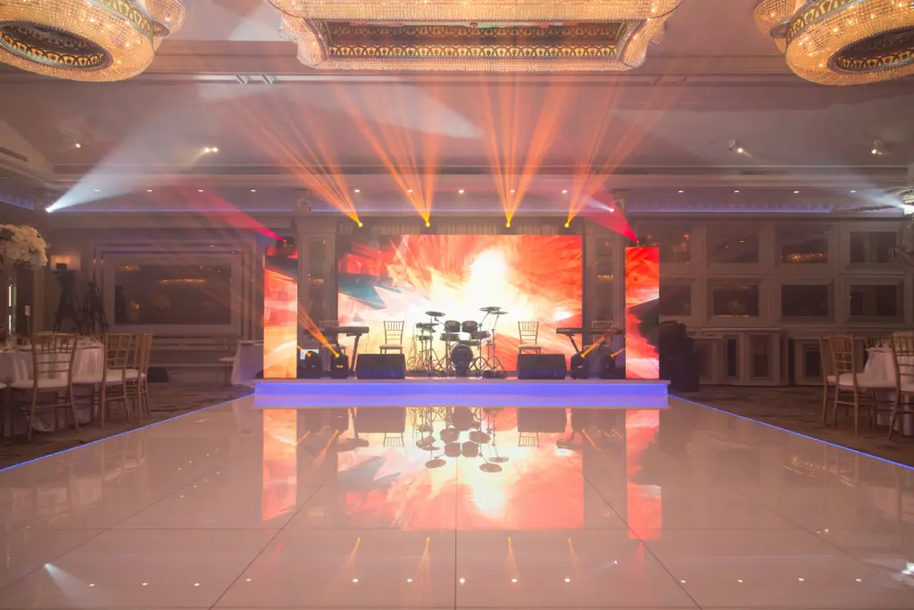 Glenoaks Ballroom dance floor with colorful stage lighting and a live band setup
