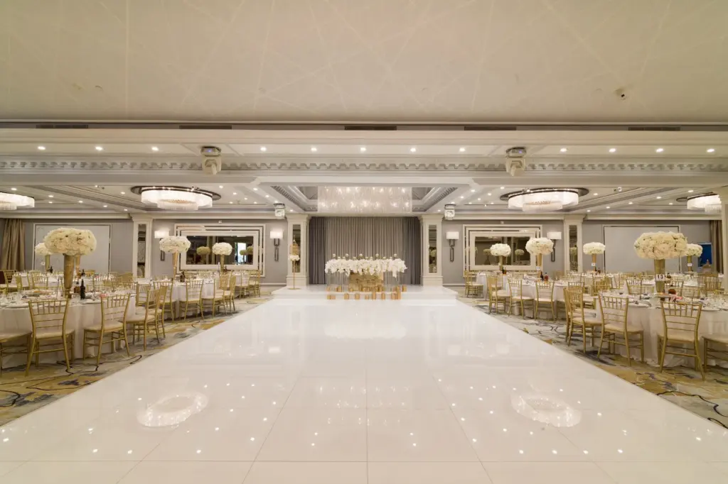 Glenoaks Ballroom aisle lined with tall white floral centerpieces leading to the dance floor