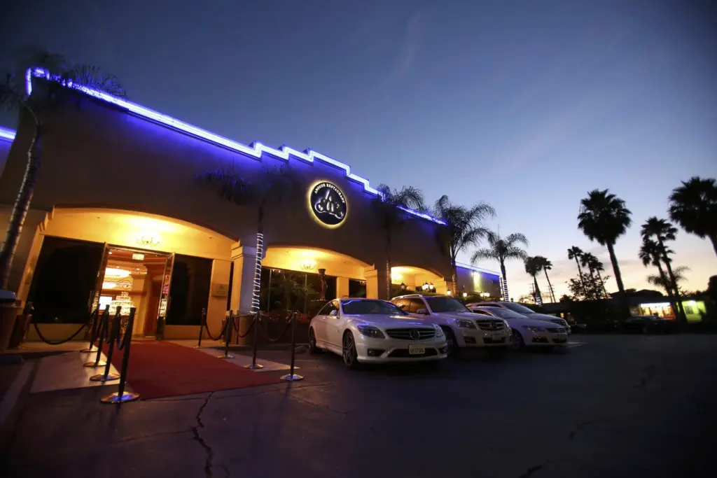Glenoaks Ballroom exterior entrance at dusk with blue neon trim and a red carpet