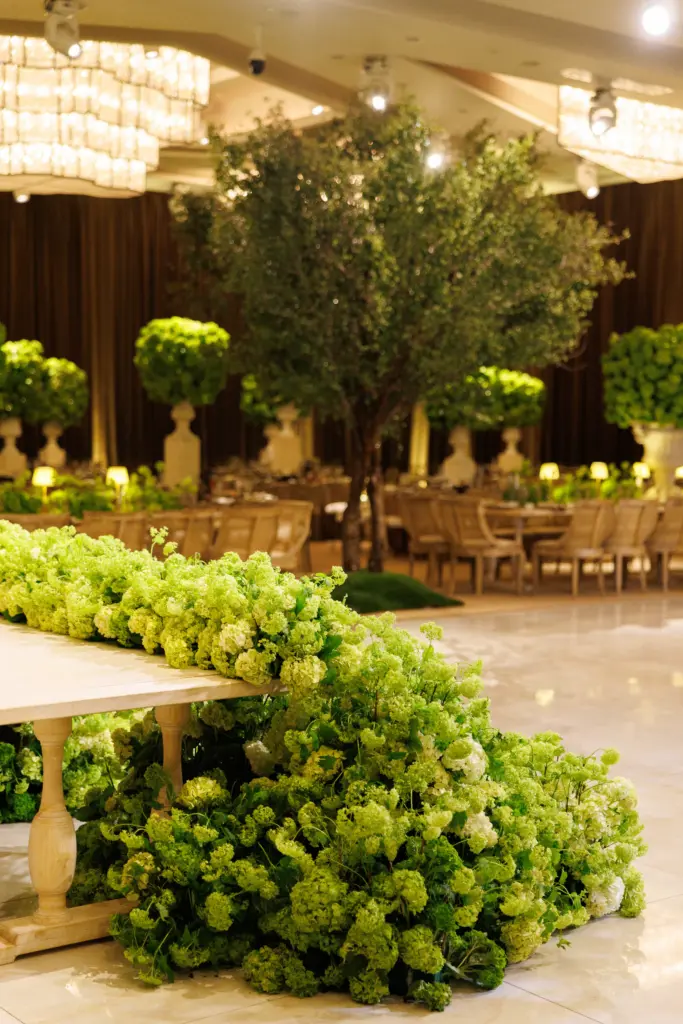 Green and white floral table runner cascading onto the floor at The Landmark ballroom