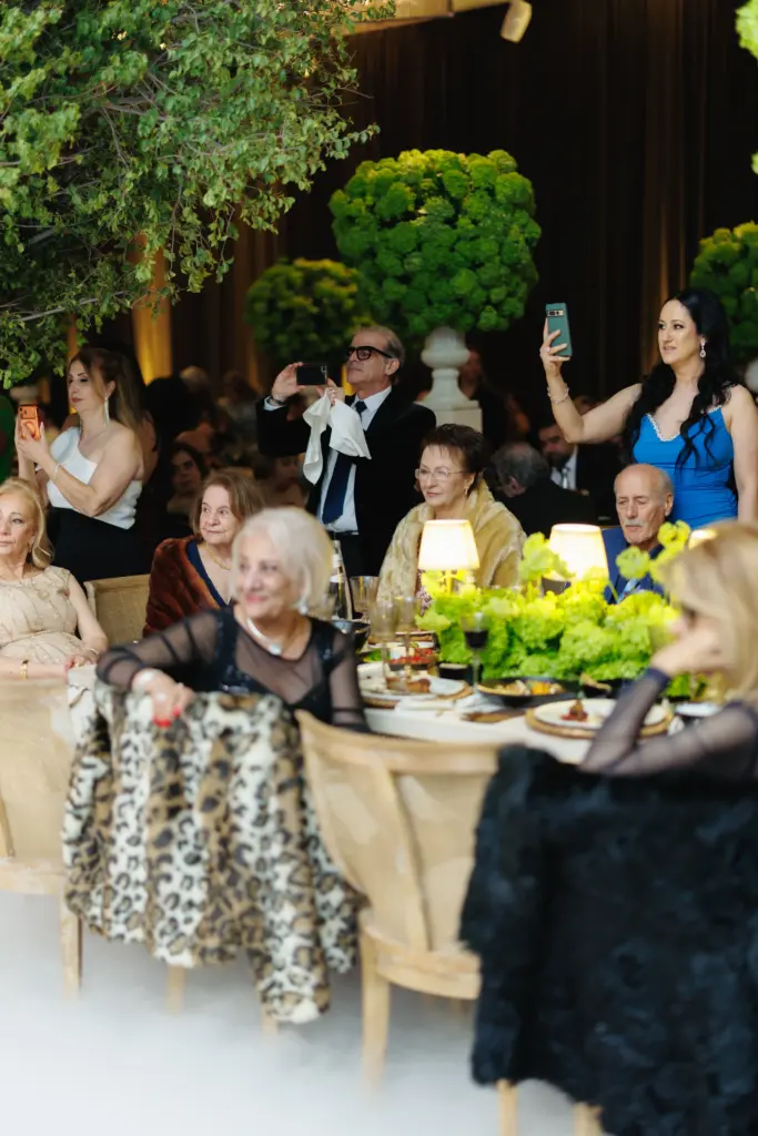 Wedding guests photographing the celebration from their table at The Landmark