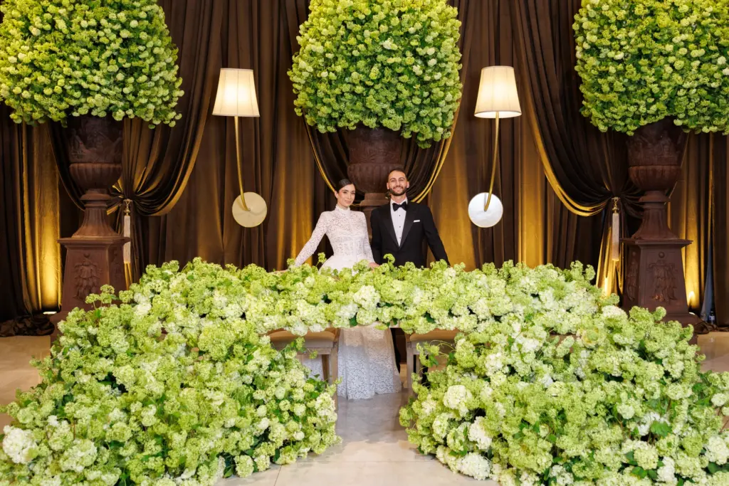 Guests dancing on the reception dance floor under colorful lighting