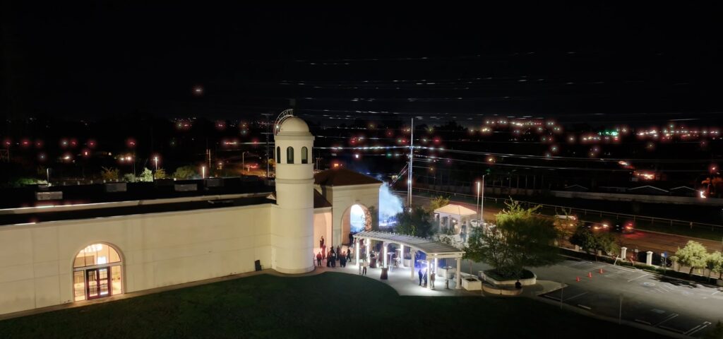 Aerial view of an outdoor ceremony chair arrangement radiating from a round stage on The Landmark's lawn