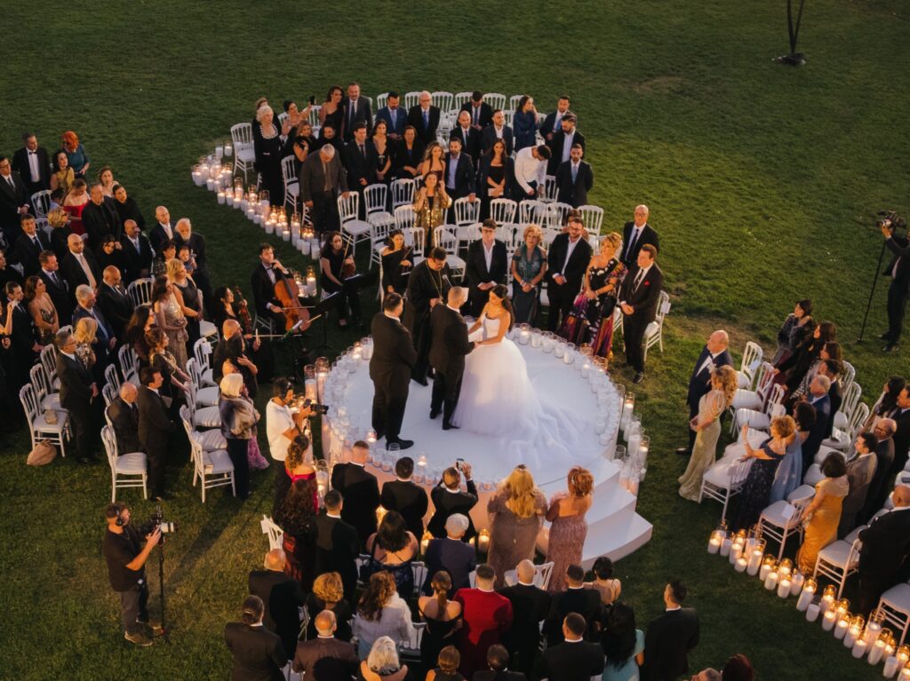 The Landmark's tower illuminated at night above an outdoor wedding ceremony with mountain views
