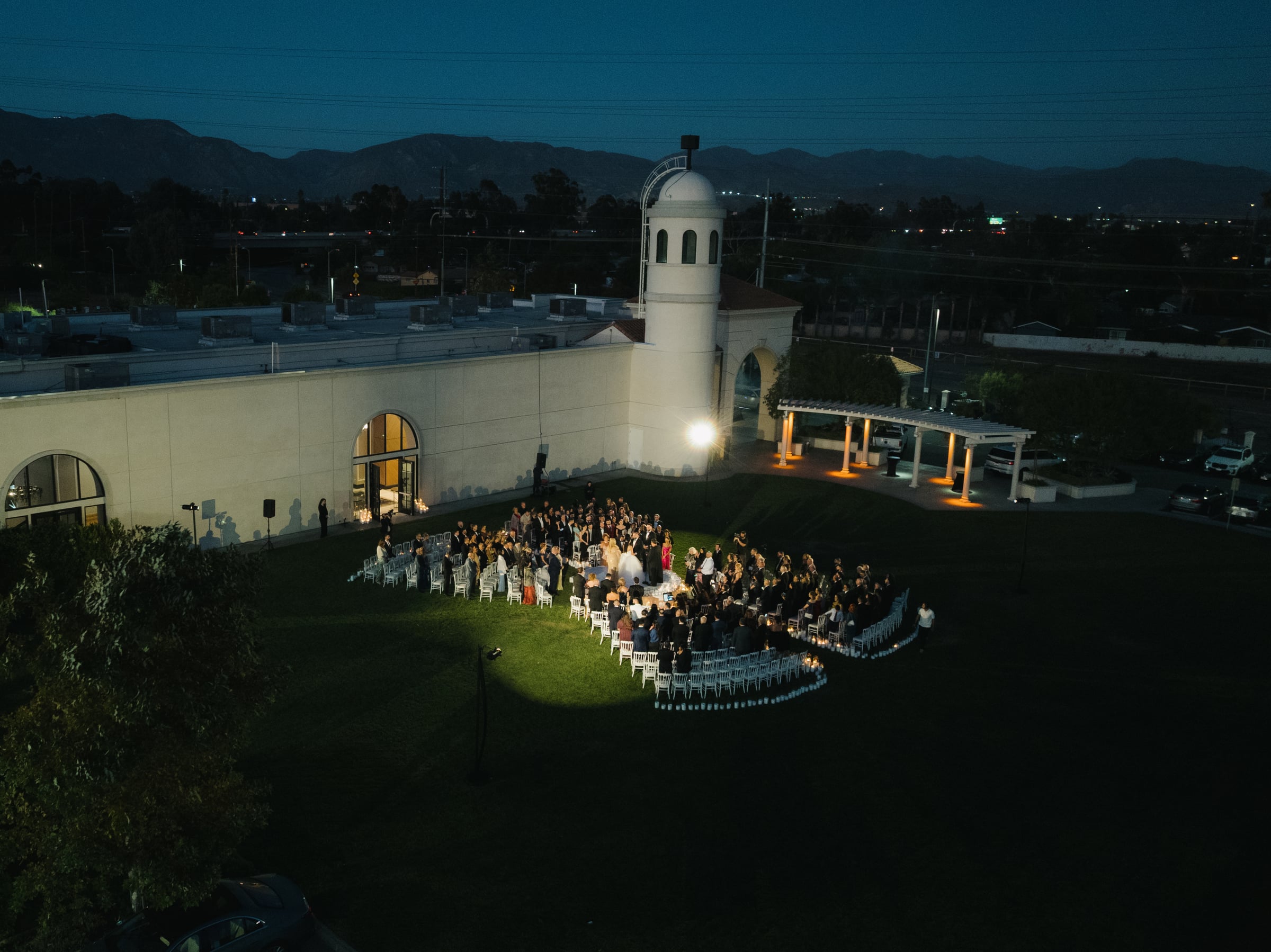 Outdoor wedding ceremony aisle at The Landmark lined with white chairs leading to the altar