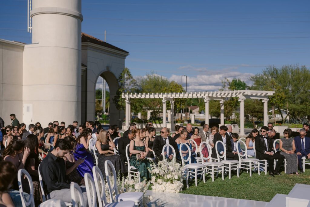 Nighttime wedding ceremony at The Landmark under a string-light canopy with a reflective aisle