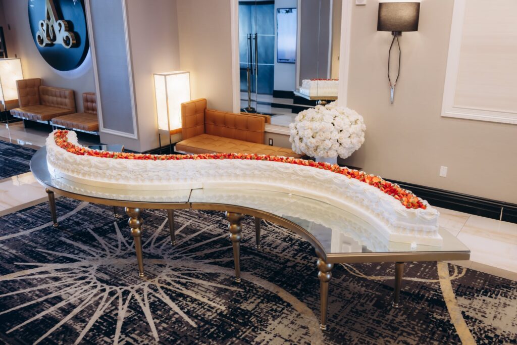 S-shaped strawberry-topped wedding cake displayed in The Landmark's lounge area