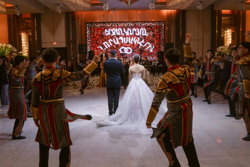 Bride and groom greeted by traditional Armenian dancers in costume