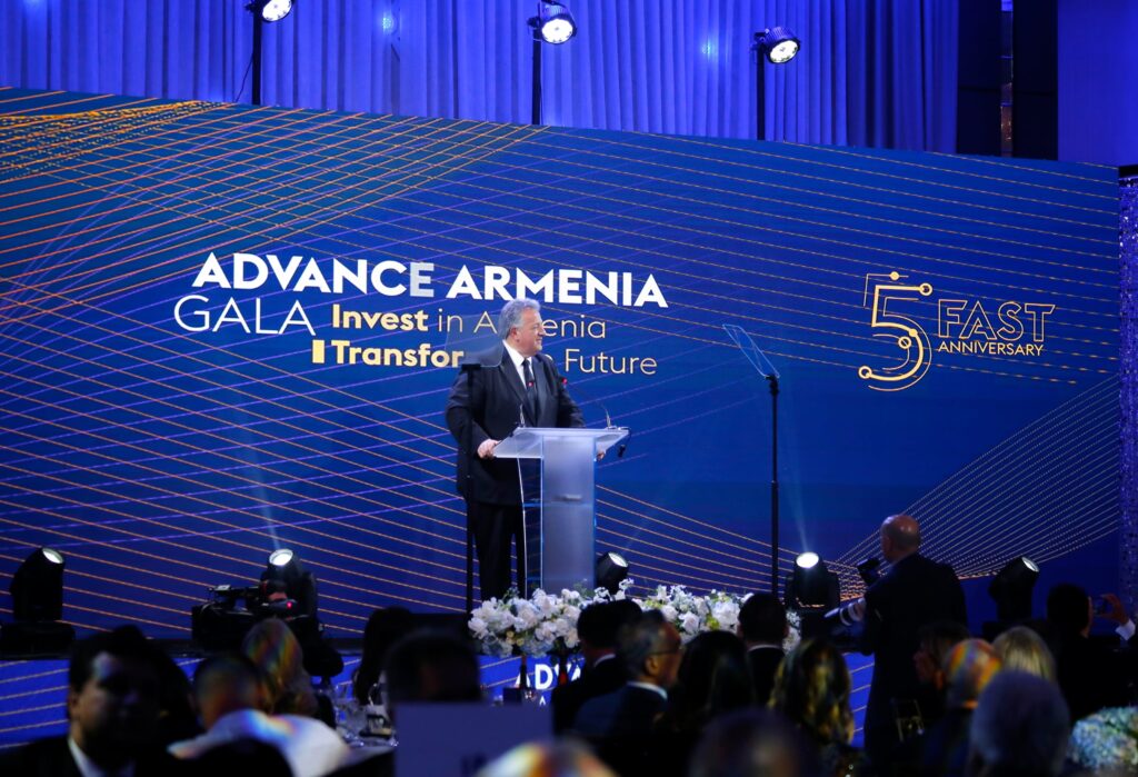 Speaker addressing guests from a podium at the Advance Armenia Gala