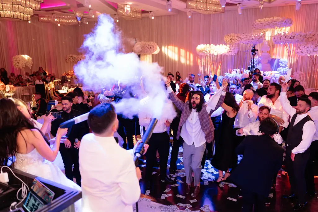 Wedding celebration on the dance floor at The Landmark with fog and falling money