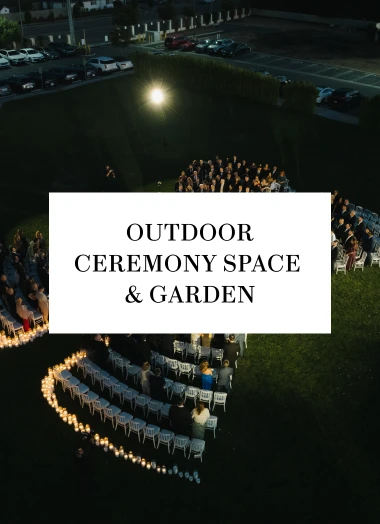 Aerial night view of an outdoor ceremony garden lined with candlelit chairs
