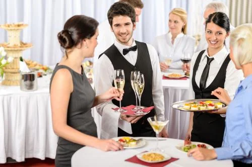 waiters serving guests catered event