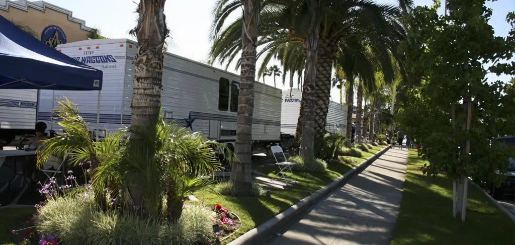 Film production trailers along a palm-lined walkway at Glenoaks Ballroom