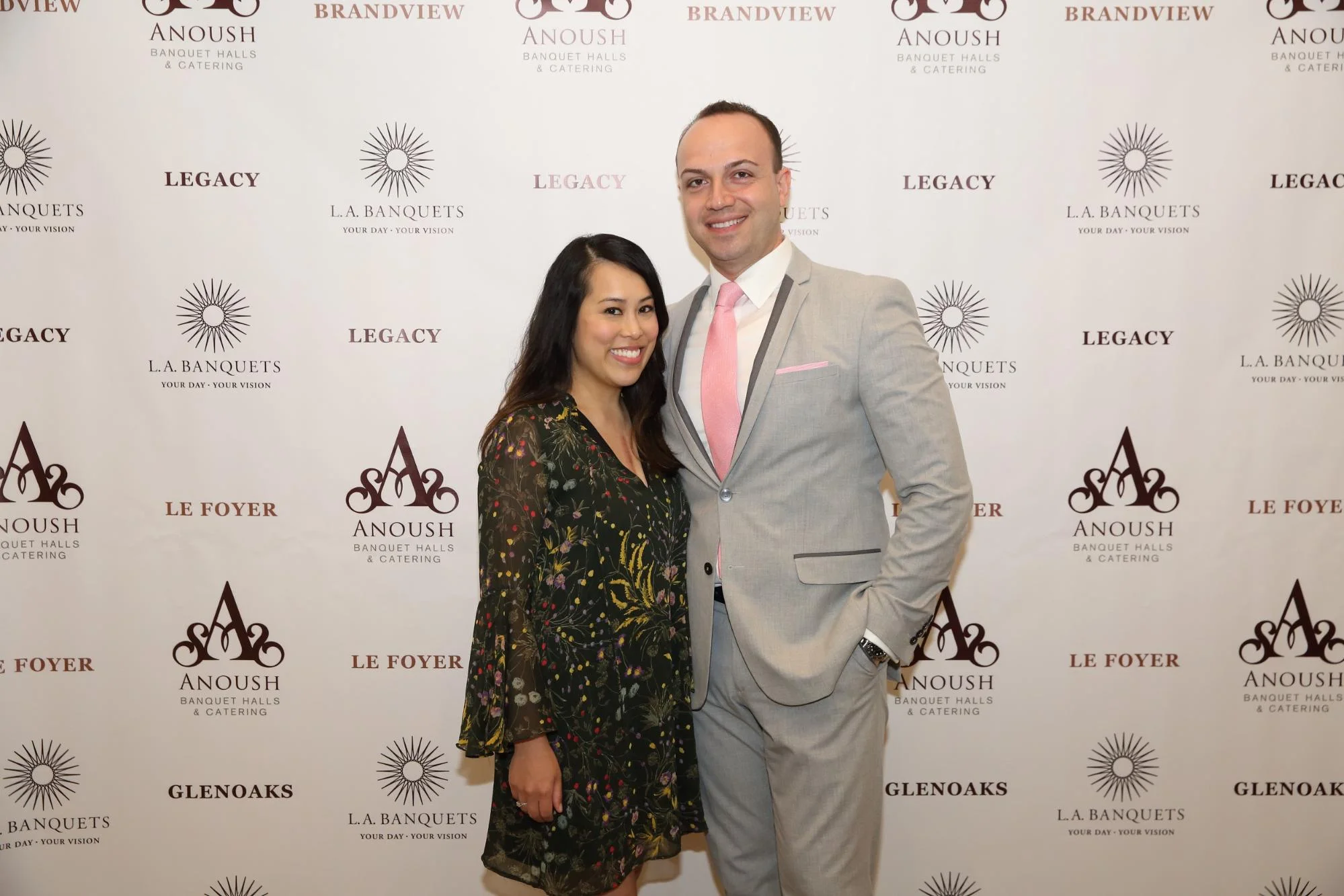 Couple posing at an L.A. Banquets step-and-repeat backdrop