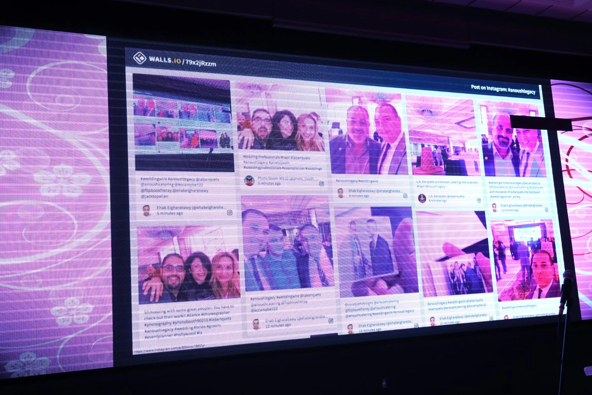 Large screen displaying a live social media photo wall at an event