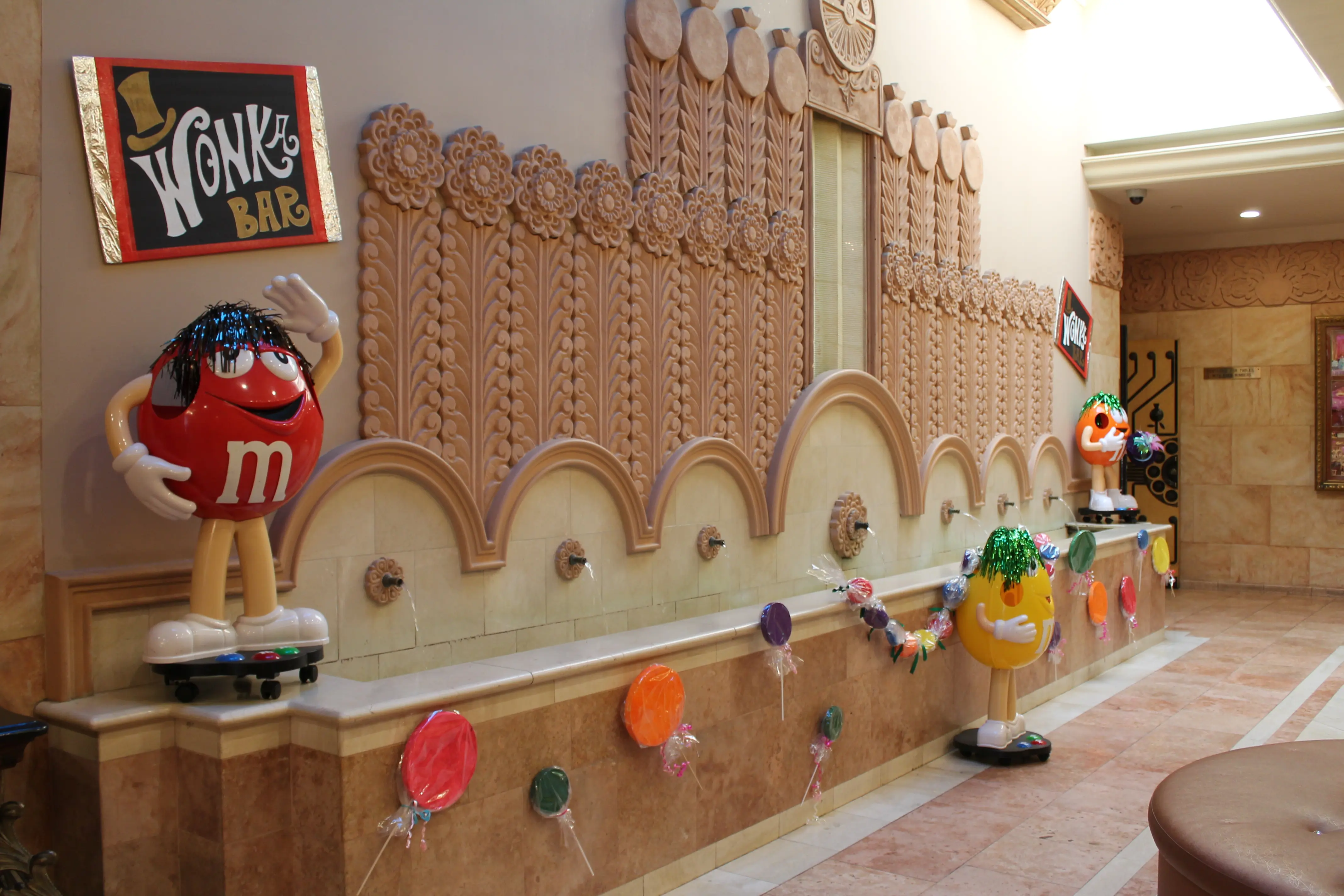 Willy Wonka-themed candy wall decoration with an M&M mascot at a special-needs prom