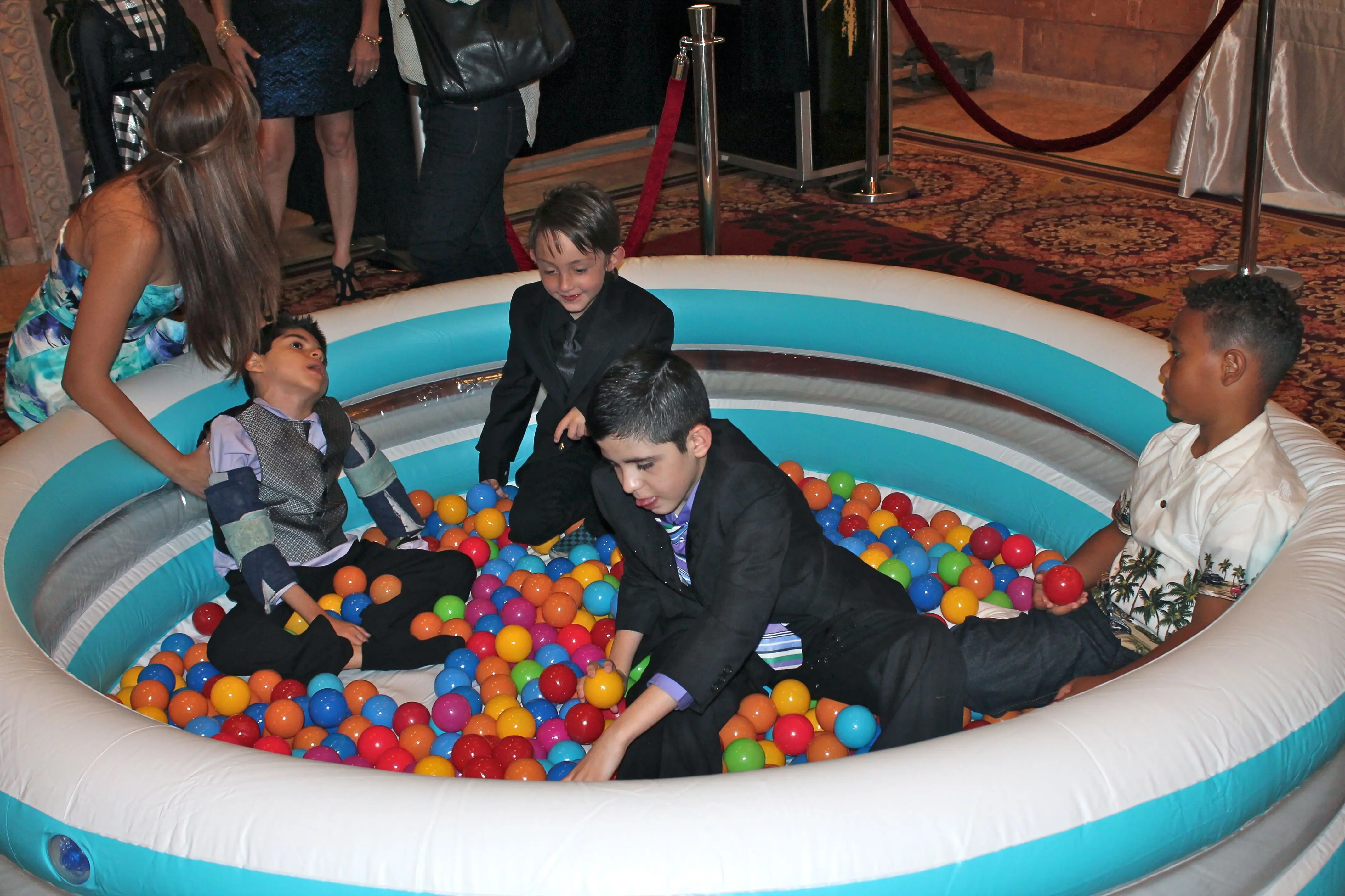 Children playing in a ball pit at a special-needs prom event
