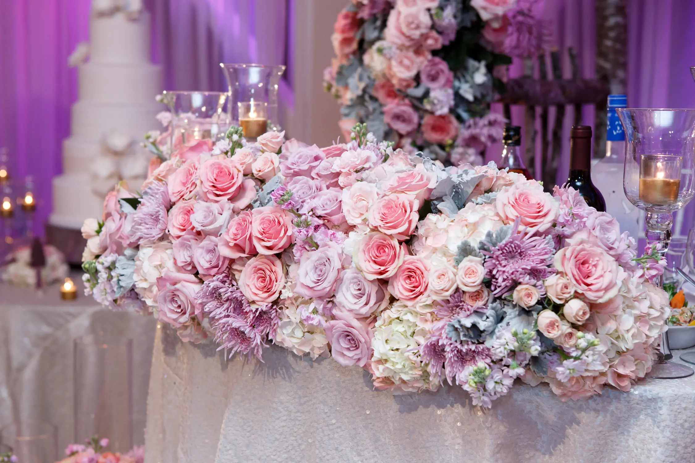 Close-up of a pink rose centerpiece arrangement on the reception table
