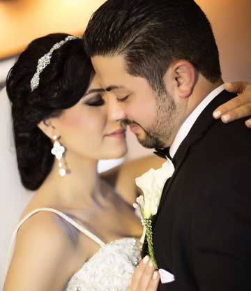 Bride and groom sharing a close forehead-to-forehead moment