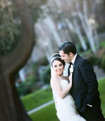 Bride and groom embracing in a garden setting