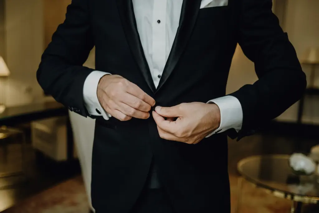 Groom adjusting his tuxedo