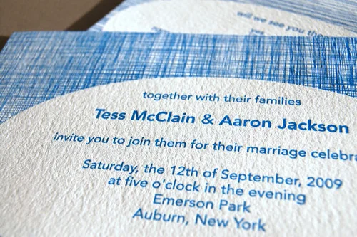 Wedding invitation printed in blue ink on linen-textured paper