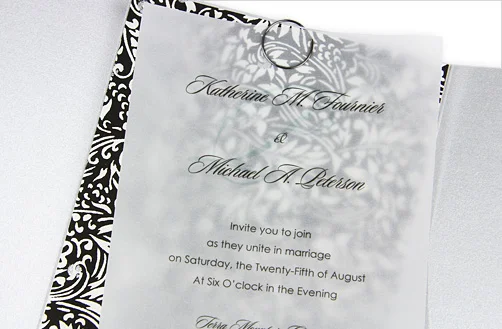 Vellum overlay wedding invitation with a black-and-white damask liner