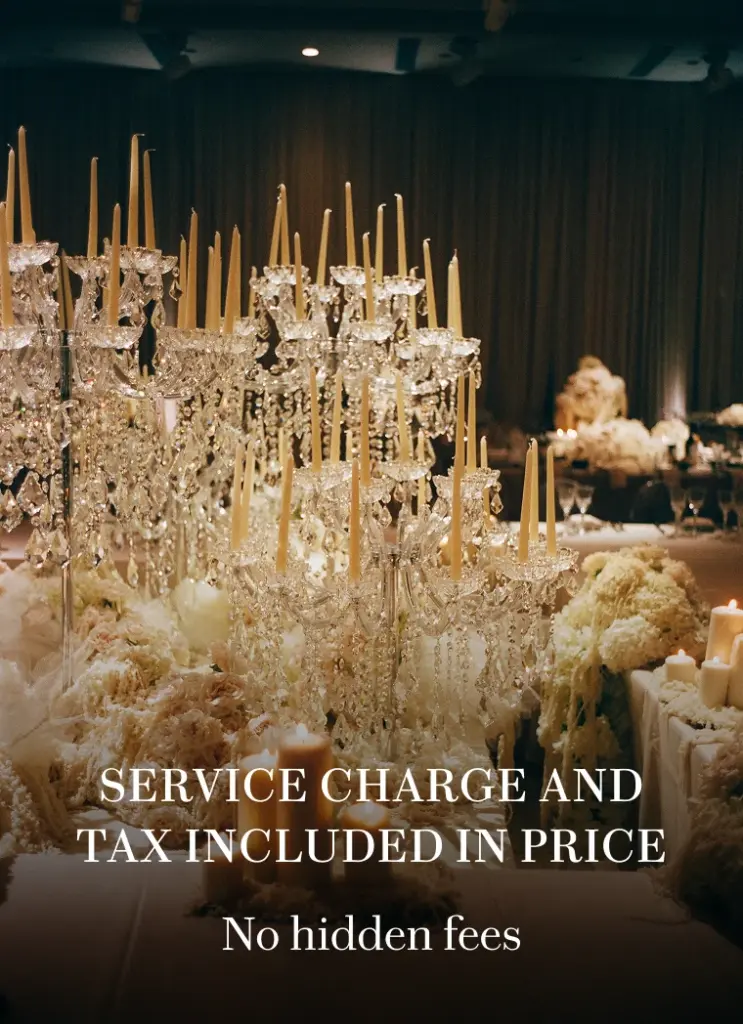 Crystal candelabra centerpiece with candles and blush florals on a reception table