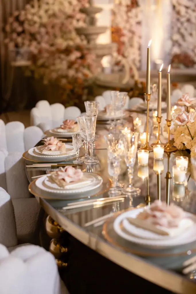 Bride and groom dancing in an ornate ballroom with floral displays and a stone fountain