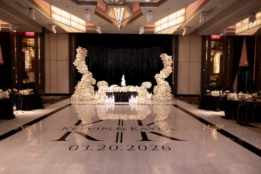 Reception dance floor with a custom couple monogram and floral arch at The Landmark ballroom
